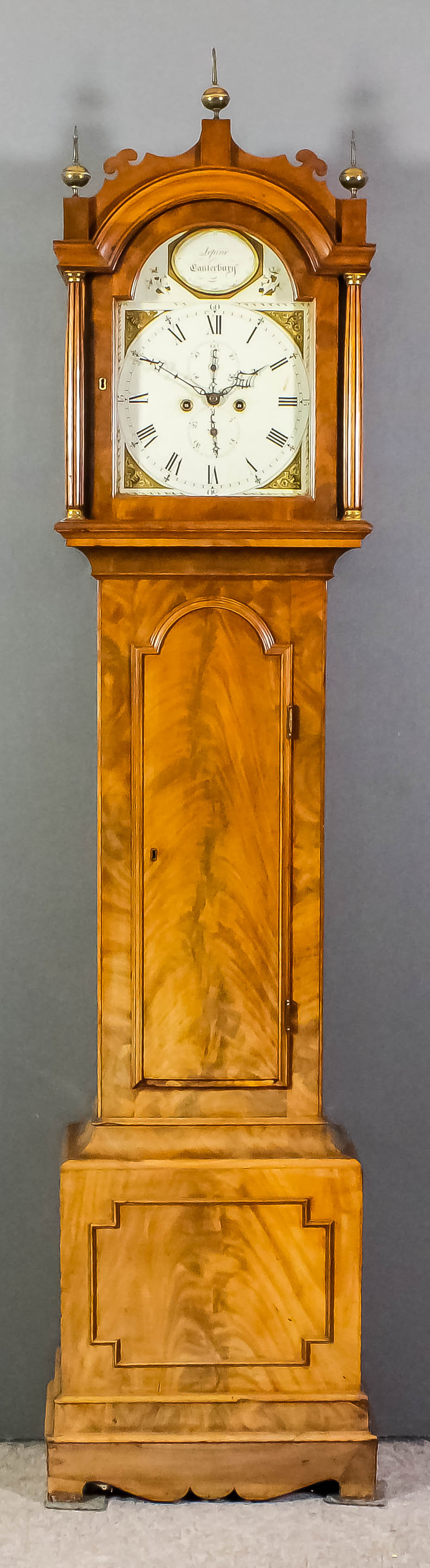 An early 19th Century mahogany longcase clock by Lepine of Canterbury, the 12ins arched painted dial