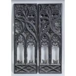 A pair of stained wood "Gothic" tracery panels, the Gothic letters "SI" and "IS" carved to the