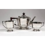 An Edward VIII silver three piece tea service with plain circular bodies and moulded girdles, each