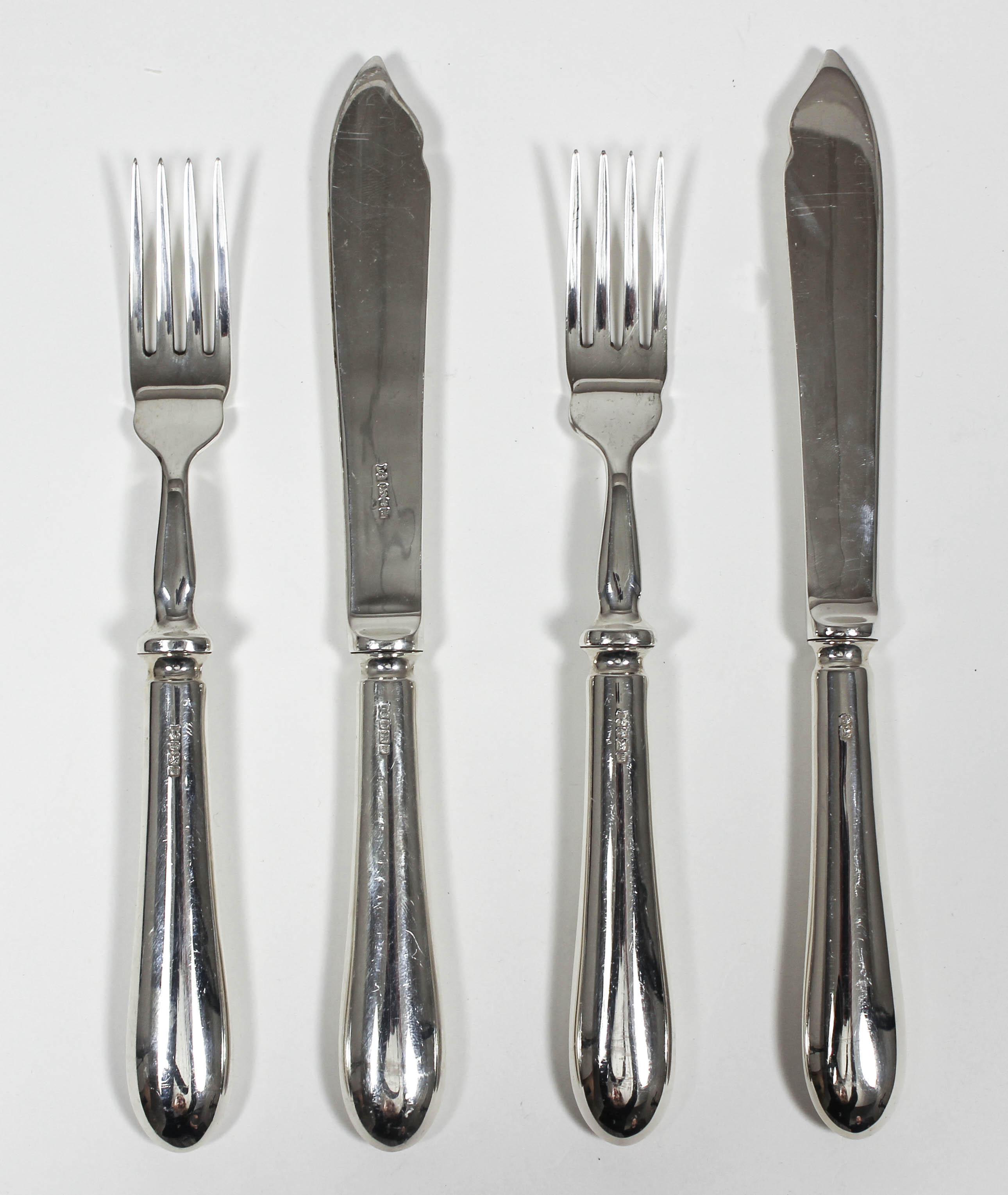 A set of six Elizabeth II silver fish knives and six fish forks with plain silver blades and plain