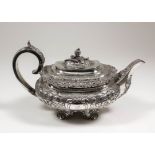 A George IV silver rectangular teapot with cast leaf scroll mounts, the whole embossed with leaf