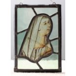 A 15th Century English stained glass panel showing the head of the Virgin Mary, 11ins x 4.5ins,