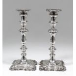 A pair of George IV silver pillar candlesticks of mid 18th Century design with square sconces and