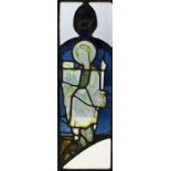 A 15th Century English stained glass panel of a female saint holding a sword and book, 73ins x 7.