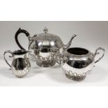 A late Victorian Scottish silver spherical teapot with urn pattern finial, part reeded and fluted