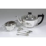A George VI silver octagonal teapot of panelled form with ebonised angular handle, 6.5ins high, by