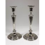 A good pair of George III cast silver pillar candlesticks and pair of matching two light