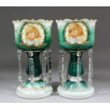 A pair of Victorian opaline and green glass lustres decorated with vignettes of children, each 11.