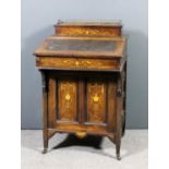 An Edwardian rosewood Davenport inlaid with stringings, urns, swags and scroll ornament, the