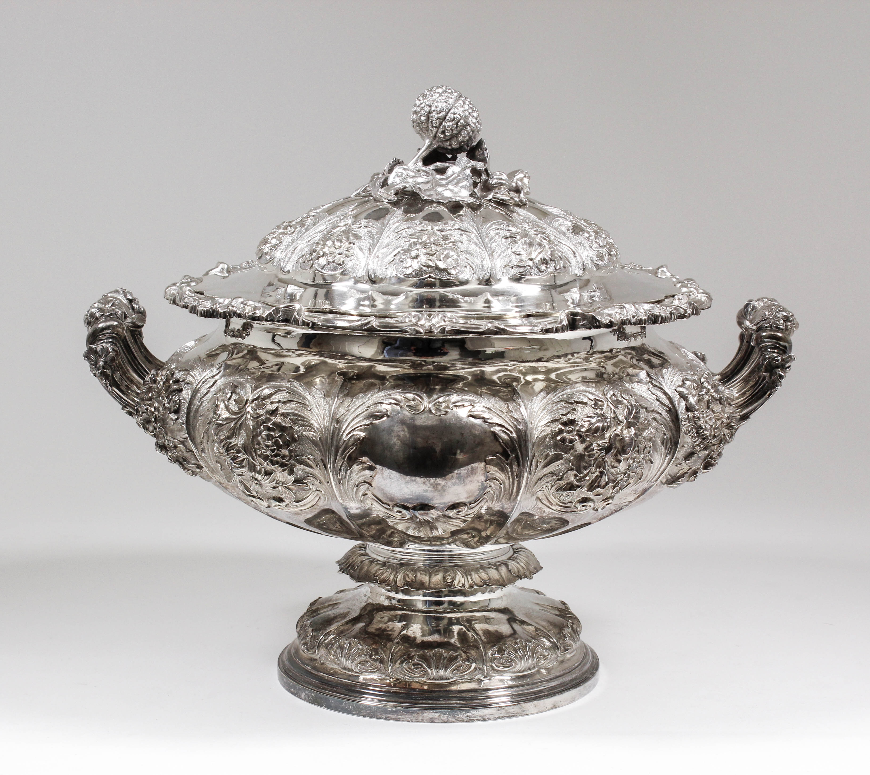 A good George IV silver circular two-handled tureen and cover, the squat lobed body with bold cast