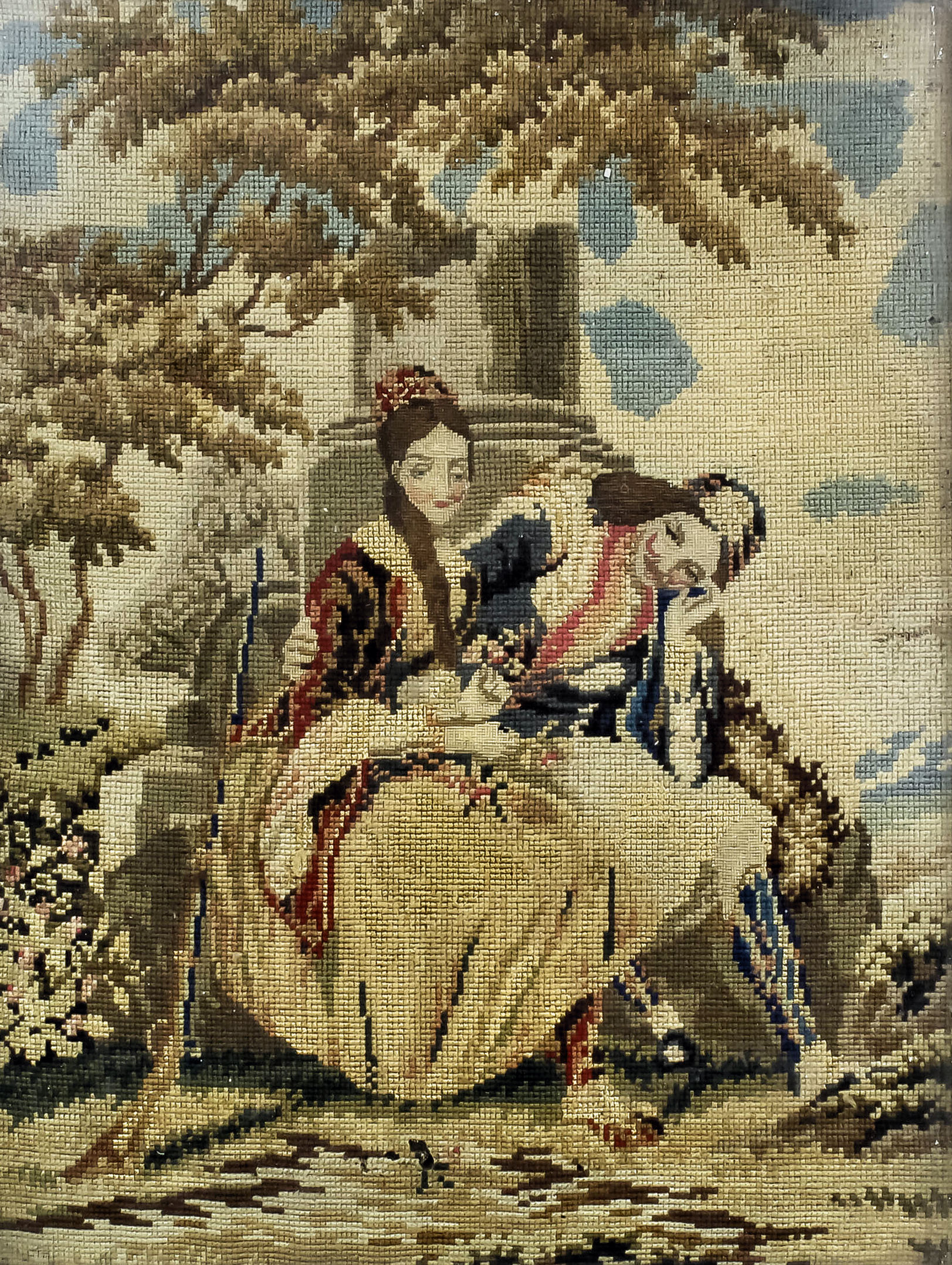 A Victorian needlework panel worked in coloured wools of a young man and a woman beside a pillar