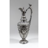 A Victorian silver claret jug, the whole boldly cast with wing, wreath, scroll, leaf and reeded