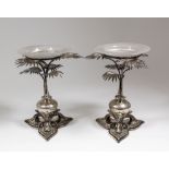 A pair of Victorian silver and parcel gilt table centres in the "Egyptianesque" manner, modelled