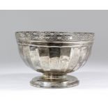 A George V silver circular bowl with pierced rim and panelled body on circular footrim, 8.75ins