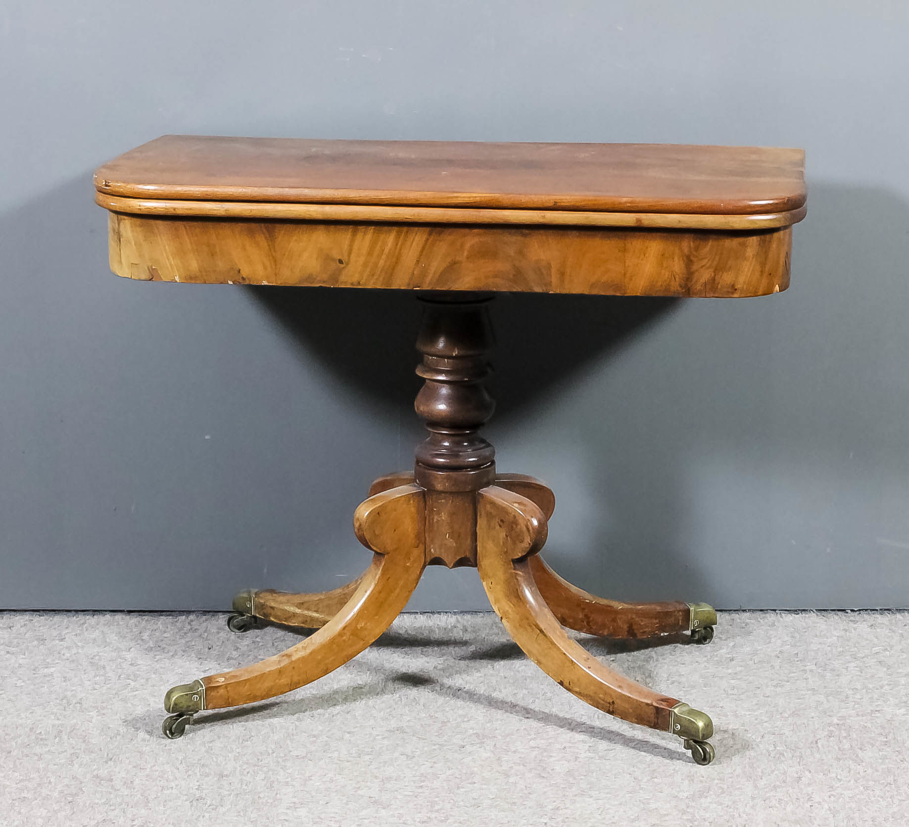 A George IV mahogany rectangular tea table with rounded corners, the plain folding top on turned