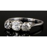 A modern silvery coloured metal mounted diamond three stone ring, the central old cut stone