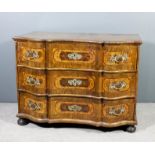 An 18th Century North German walnut commode of bold shaped outline, the top and side panels inlaid