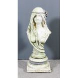 A modern composition stone bust of a young woman with long hair dressed with a lead flowering