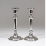 A pair of American Sterling Silver pillar candlesticks with gadroon mounts, tapered stems and on