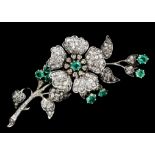 A late Victorian gold and silvery coloured metal mounted emerald and diamond set flower pattern