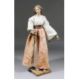 A late 18th Century Neapolitan crib figure of a young woman, her right arm extended and pointing,