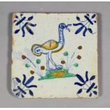 A 17th century Dutch Delft maiolica polychrome tile of a long necked bird with a worm and with