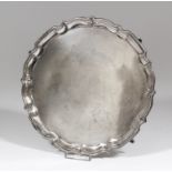 An Edward VII silver circular salver with moulded piecrust rim, on four pad feet, 10.25ins diameter,