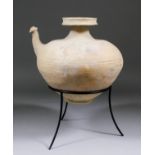 A buff earthenware Cambodian Kendi with a broad shoulder, narrow foot, wide mouth with flange and