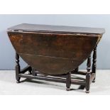 A 17th Century oak oval gateleg table, fitted two frieze drawers, on turned supports, 47.5ins x