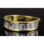 A modern 18ct gold all diamond set half hoop eternity ring, the face channel set with nineteen