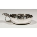 An 18th Century French plain silver circular taste-vin with cast shell and circular ring pattern