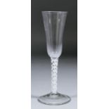 An 18th Century ale glass with slender rounded funnel bowl on double opaque white twist stem and