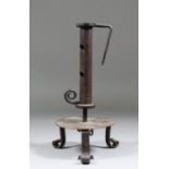 An 18th Century French wrought iron candlestick, the hollow shaft with adjustable socket, with