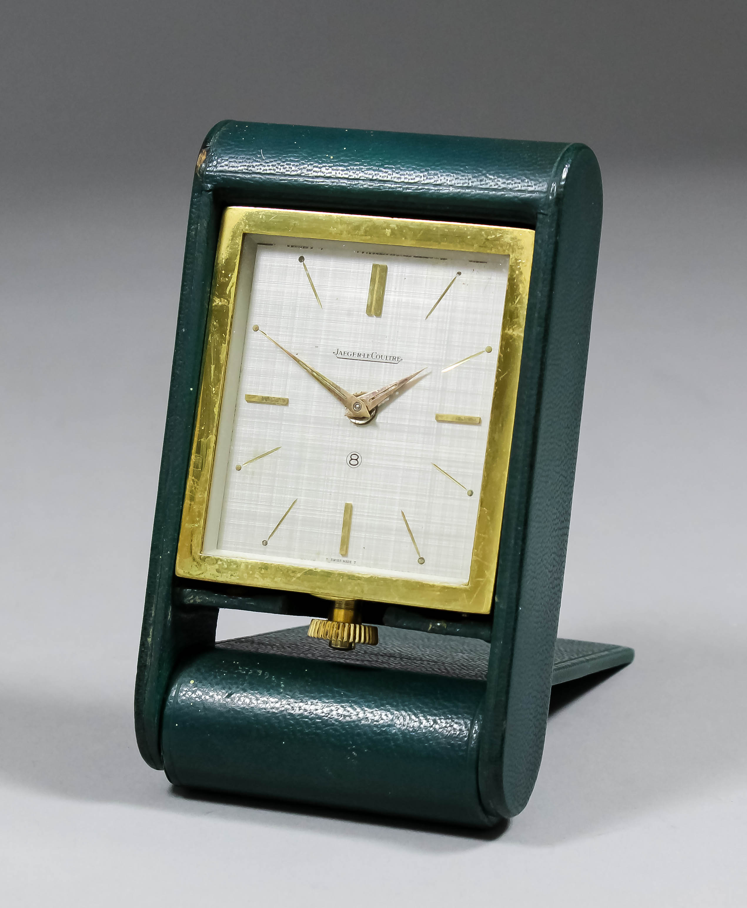 A 1960s Jaegar Le Coultre gilt metal cased travelling alarm case, No. 123273, the silvered dial with