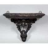 A late 19th/early 20th Century Continental carved and stained wood wall bracket, 15.75ins wide x