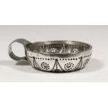 An 18th Century French silver circular taste-vin, the bowl with bold punched ornament, circular