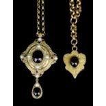 A Victorian gold coloured metal garnet set heart pattern pendant, the face set with an oval cabochon