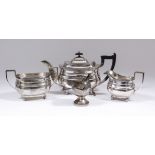 A George V silver rectangular three piece tea service of Georgian design with reeded mounts and