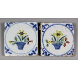 Two English 18th Century polychrome tiles painted with a flower vase within a blue circle and blue