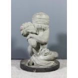 A 20th Century Indian carved green sandstone figure of "The Crouching Venus" holding aloft an urn,