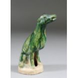 A Chinese pottery green glazed model of a seated hound (Tang Dynasty - circa 618-906 AD)