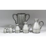 A graduated set of five English pewter jugs with flared necks, 3ins high to 7.75ins high, each