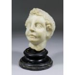 A 15th Century Northern European white marble bust of a young boy with curly hair, 5.5ins high, on