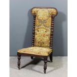 A Victorian mahogany framed low nursing chair with moulded frame on bobbin turned and carved