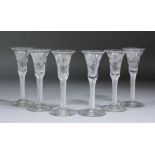 A set of six 18th century "Jacobite" wine glasses the drawn trumpet bowls engraved with six-petalled