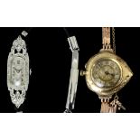 A 1920s lady's silvery coloured metal and all diamond set cocktail watch, the oval face with