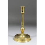 A 16th Century French copper alloy candlestick, the shaft with urn shaped knop above a shallow