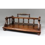 A late 19th Century mahogany double sided book stand, on reeded bun feet, 17.5ins wide x 11.75ins
