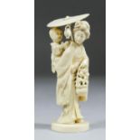 A Japanese carved ivory figure of a woman carrying a child on her back, 5.25ins (133mm) high, (