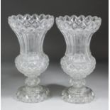 A pair of 19th Century panel and diamond cut-glass urn shaped vases, each 12.5ins high